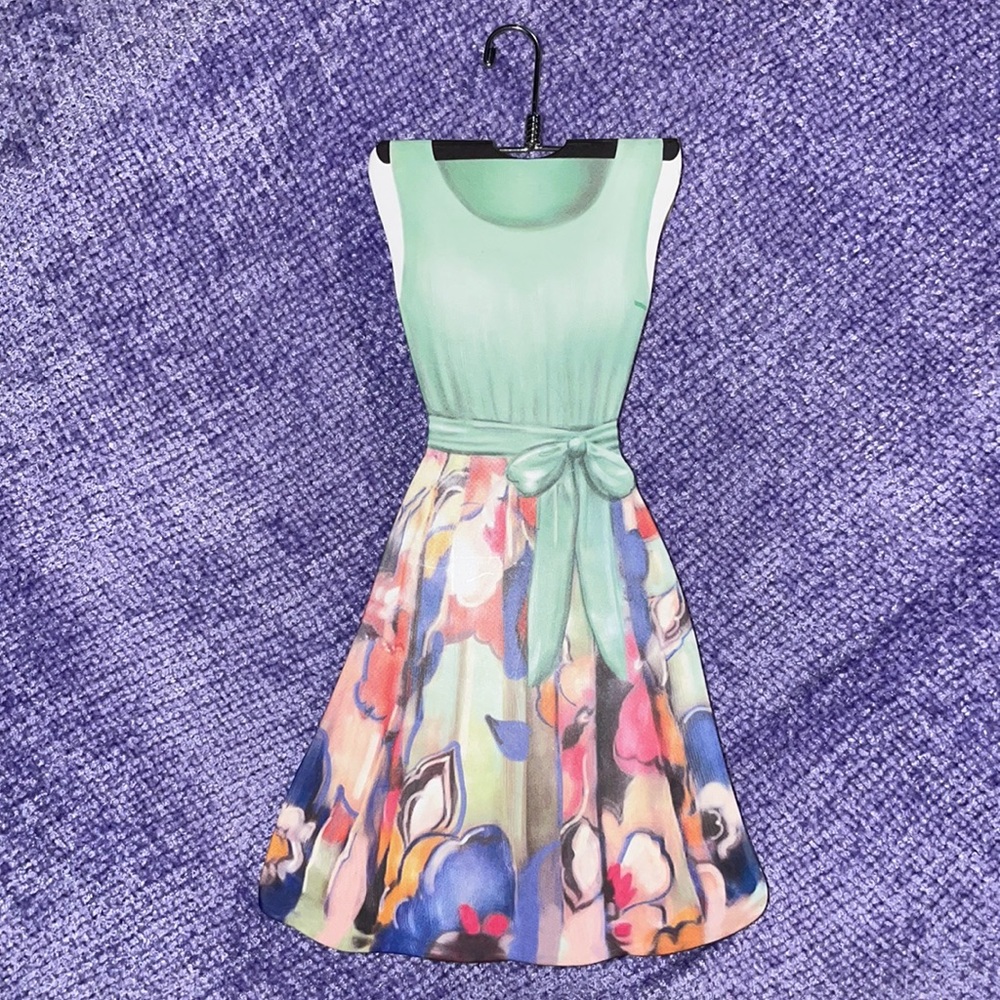 Lily McGee notepad on metal hanger floral skirt green top pastel pages dress